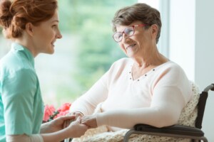 Older Adults' Dental Care - Dental professional tending to a woman in a wheelchair